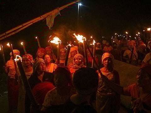 Activists of the Meiti community carry out a torch rally to protest the arrest of alleged suspects in Pechi Awang Leikai village of the Thoubal district of north eastern state of Manipur