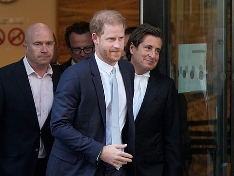 Prince Harry, centre, and David Sherborne, Prince Harry's lead lawyer, right, leave the High Court after giving evidence in London, Wednesday, June 7, 2023.