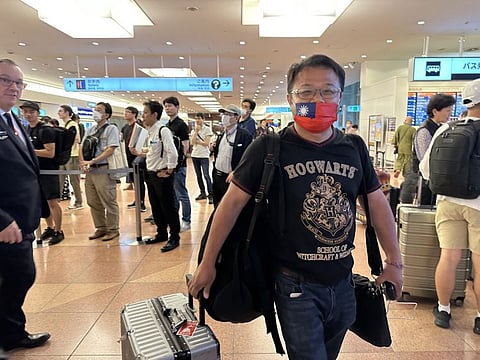 Lee Meng-chu arrives at Tokyo’s Haneda airport on Monday in a mask.