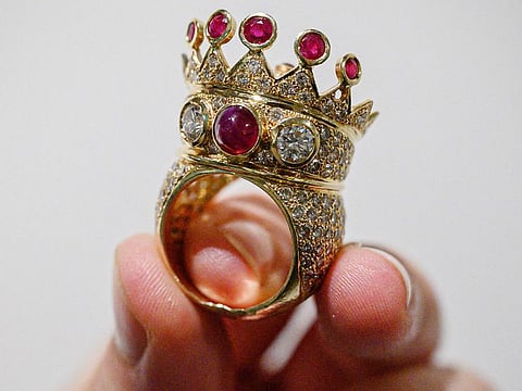 A gold, ruby, and diamond crown ring, designed and worn by the late US rapper Tupac Shakur during his last public appearance in 1996, is displayed during a press preview at Sotheby's in New York City.