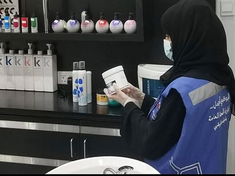 An Abu Dhabi Municipality inspector checking products at a beauty salon as part of inspection campaign to ensure safety standards at barbershops, women’s beauty salons and gymnasiums