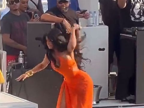 Cardi B throws the microphone at someone in the audience.