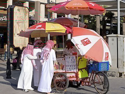 Men buy ice cream as they shop at al-Mubarakiya market amid soaring temperatures in Kuwait City.