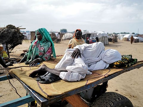 A Sudanese man suffering from malaria lies on a cart as he waits for a clinic to open, in Adre, Chad on August 2, 2023.
