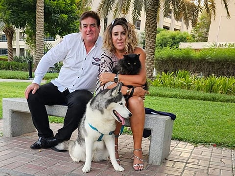 British expat David Tobias and his wife Dalila Tobias, who is Moroccan-French, with their cat Midnight and dog Alaska. The two pets always sleep side by side.