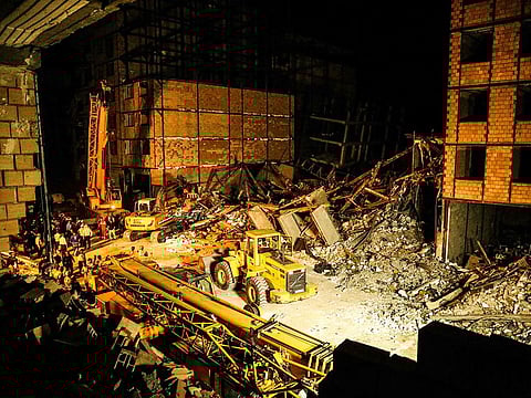 Rescue personnel gather at the site of a collapsed building in Tehran on August 6, 2023.