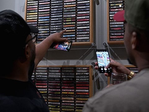 People attend "Hip Hop Til Infinity," a new immersive exhibit, at the Hall des Lumieres in New York City