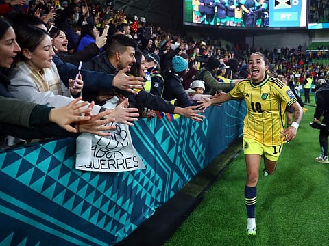 Colombia's Carolina Arias celebrates with fans after the match as Colombia progress to the quarter-finals of the World Cup.