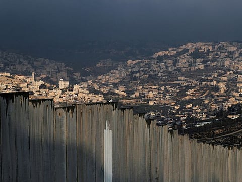 A general view picture shows part of East Jerusalem neighbourhoods behind the Israeli barrier.