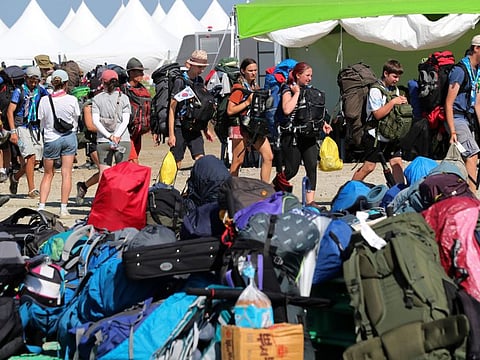 Attendees of the World Scout Jamboree leave a scout camping site in Buan, South Korea,on August 8, 2023.