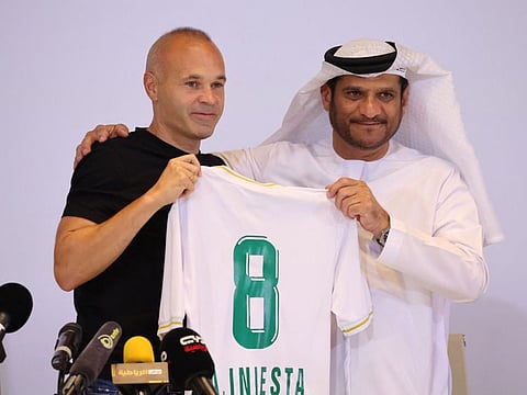 Spanish midfielder Andres Iniesta poses with his new jersey alongside Emirates Club Chairman Youssef Abdullah Al Batran during a press conference in Ras Al Khaimah yesterday.