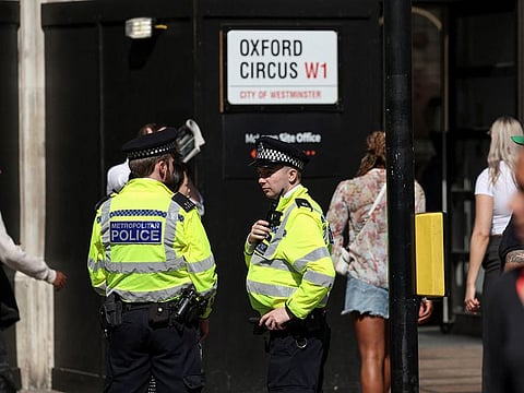 Police officers keep watch as disruptors are expected to target shops during a shoplifting spree flash mob on Oxford Street in London, Britain.