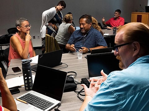 Dr. Stephanie Laggini Fiore, Associate Vice Provost and Sr. Director of the Center for the Advancement of Teaching, back, hosts a faculty teaching circle on artificial intelligence on Wednesday, Aug. 9, 2023, at Temple University in Philadelphia.