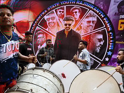 Fans play drums before the screening of Indian actor Rajinikanth's new Tamil-language movie 'Jailer' on the first day of its release, outside a theatre in Mumbai on August 10, 2023