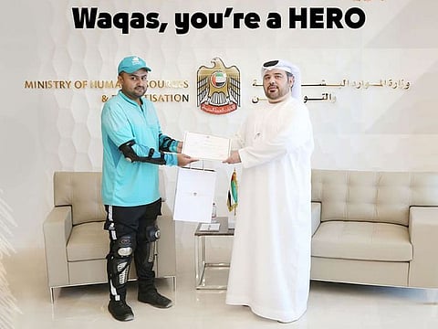 MOHRE honours delivery rider for his timely action in removing blocks from a road for the safety of other motorists on the road