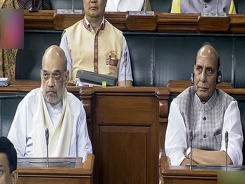 India's Union Home Minister Amit Shah and Union Defence Minister Rajnath Singh in Lok Sabha during the ongoing Monsoon Session of Parliament, in New Delhi on Thursday
