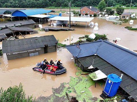 Rescue workers on a boat search for missing people in floodwaters caused by the tropical storm named Khanun in Daegu, South Korea, Thursday, Aug. 10, 2023.