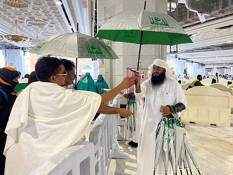 Umbrellas are offered to Umrah pilgrims at the Grand Mosque in Mecca.
