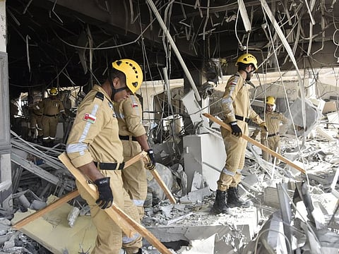 Civil Defence and Ambulance Authority personnel at the blast site.