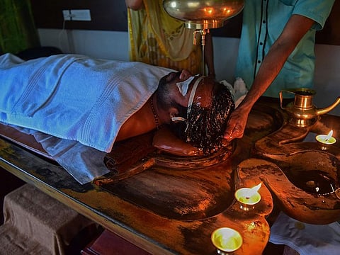 A patient undergoes the 'Shirodhara' treatment at SGVP Holistic hospital on the outskirts of Ahmedabad.