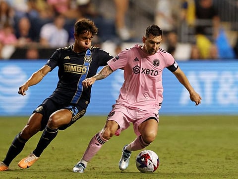 Inter Miami forward Lionel Messi fights for the ball against Philadelphia Union midfielder Quinn Sullivan during the second half at Subaru Park.