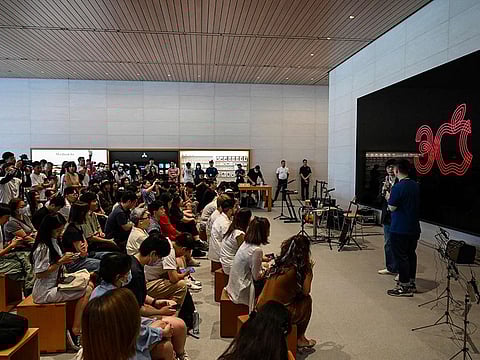 People attend an event celebrating Apple's 30th anniversary in China at an Apple retail store in Beijing on August 18, 2023.