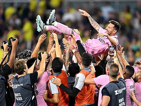 Teammates hold up Inter Miami's Argentine forward #10 Lionel Messi as they celebrate after winning the Leagues Cup final football match against Nashville SC at Geodis Park in Nashville, Tennessee.