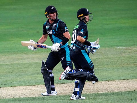 Will Young (left) and Mark Chapman of New Zealand take a run during the third T20I match against the UAE at Dubai International Cricket Stadium on Sunday.