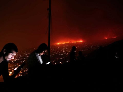 A view shows a fire over the mountains near empty houses after the evacuation in different villages in the north, as wildfires rage out of control on the island of Tenerife, Canary Islands, Spain August 20, 2023.