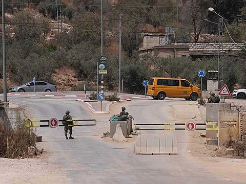 Israeli security forces block a road in Baita village on August 20, 2023, during the search for the suspected perpetrator of an attack a day earlier which killed two Israelis in Huwara village in the occupied West Bank.