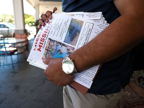 Tim Laborte holds 'MISSING' flier featuring a photo of his stepfather, Joseph Lara, who is missing since the Maui Fire raged through Lahaina, in Hawaii.