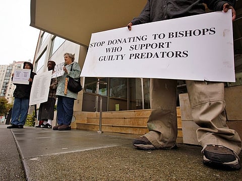 File photo: Members of SNAP (the Survivors Network of those Abused by Priests) hold up signs during a demonstration in front of the archdiocese headquarters in San Francisco. San Francisco's Roman Catholic archdiocese filed for bankruptcy Monday, saying the filing is necessary to manage more than 500 lawsuits alleging child sexual abuse by church officials.