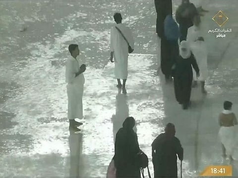 Umrah pilgrims praying amid heavy rains and thunderstorms in Mecca.