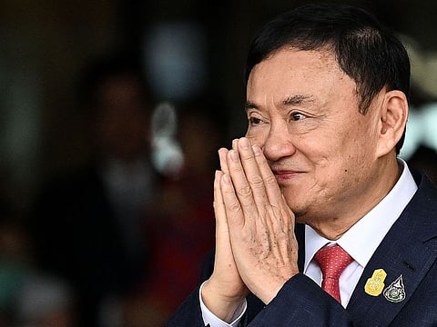 Former Thai Prime Minister Thaksin Shinawatra greets his supporters after landing at Bangkok's Don Mueang airport on August 22, 2023.
