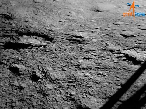 The surface of the moon can be seen beside the leg of a lunar lander The first image of the moon's surface taken by India's Chandrayaan-3 mission after its historic touchdown on Aug. 23, 2023.