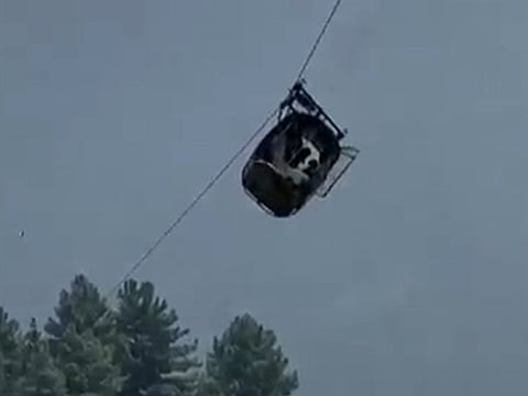 A cable car carrying six children and two adults dangles hundreds of metres above the ground in the remote Battagram district, Khyber Pakhtunkhwa, Pakistan on August 22, 2023.
