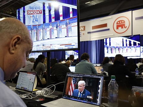 A reporter watches former President Donald Trump's online interview with Tucker Carlson in the media filing center during the first Republican candidates' debate of the 2024 presidential campaign in Milwaukee, Wisconsin.