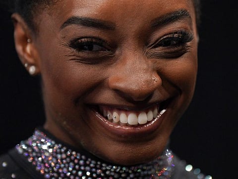 Gymnast Simone Biles smiles on the final day of womens competition at the 2023 US Gymnastics Championships.