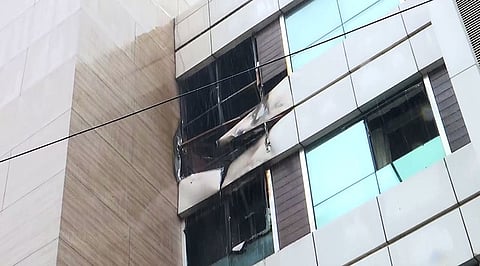 A view of damaged windows after a fire broke out in the Galaxy Hotel in the Santacruz area of Mumbai on Sunday.