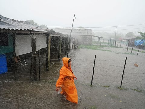 A woman walks on a flooded street as Storm Idalia makes landfall in Cuba, Guanimar, Cuba, on August 28, 2023.