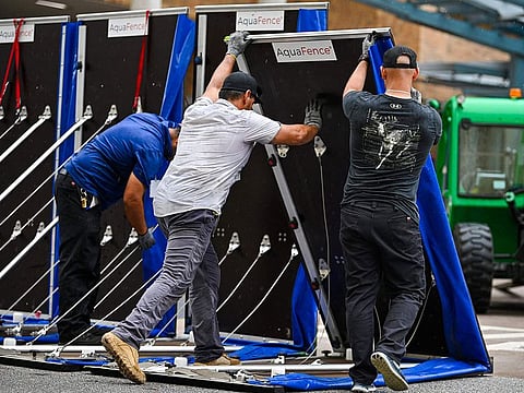 Workers set up a fence to prevent flooding at Tampa General Hospital in Tampa, Florida.