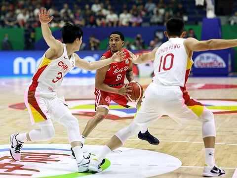 Puerto Rico's Tremont Waters, China's Peng Zhou and Mingxuan Hu in action during the first round match at Araneta Coliseum, Quezon, Philippines, on Wednesday.