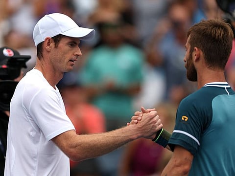 Britain's Andy Murray shakes hands with France's Corentin Moutet after winning his first round match at Flushing Meadows.