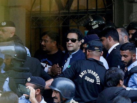 Security officers escort Pakistani former Prime Minister Imran Khan as he appeared in Islamabad High Court, Islamabad, Pakistan, May 12, 2023.