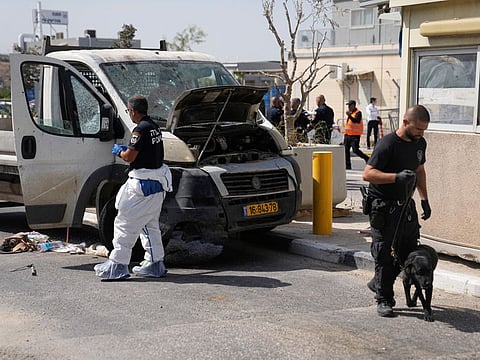 Israeli security forces inspect the scene of a Palestinian ramming attack near West Bank Maccabim checkpoint, on August 31, 2023.