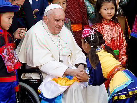 Pope Francis greets a child during a welcome ceremony at the bishop's house during his Apostolic Journey, in Ulaanbaatar, Mongolia September 1, 2023.