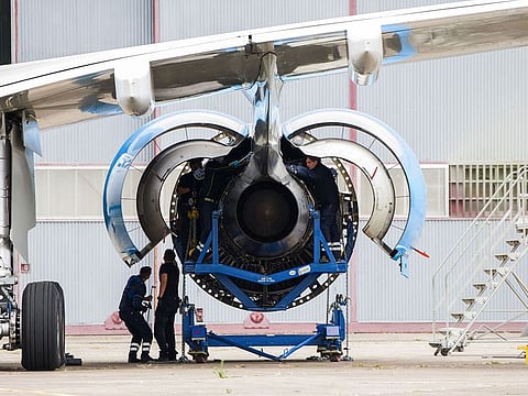 Workers carry out maintenance on a turbofan engine in Chateauroux, France.