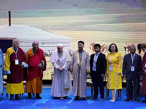 Religious leaders with Pope Francis pose for a family photo at the end of a meeting at the Hun Theatre in the Sky Resort compound some 15km south of the Mongolian capital Ulaanbaatar, on September 3, 2023.