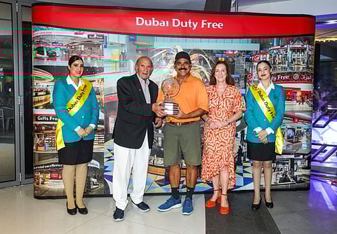 Parvez Ahmed receives the winner's trophy from Colm McLoughlin along with Sinead El Sibai, Senior Vice-President – Marketing, after the 25th DDF Seniors Cup.