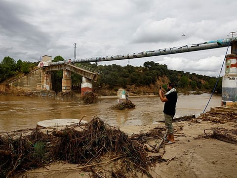 A resident takes pictures of the damage near a partially collapsed bridge, following heavy rain in Aldea del Fresno, Spain September 4, 2023.